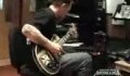 Robert Trujillo playing an acouistic guitar